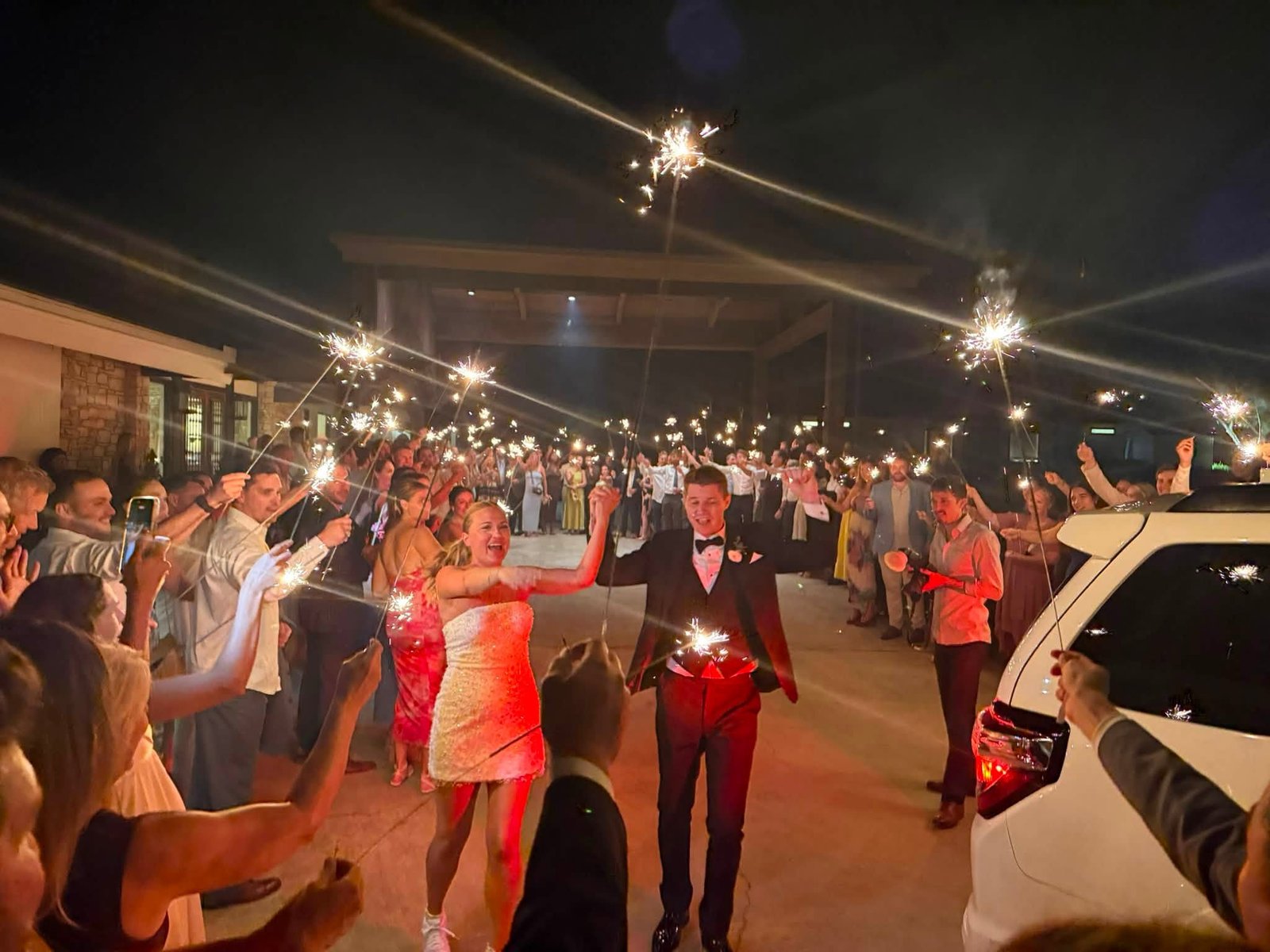 Newlyweds celebrating a sparkler grand exit